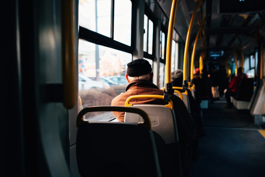 City bus with yellow holding rails